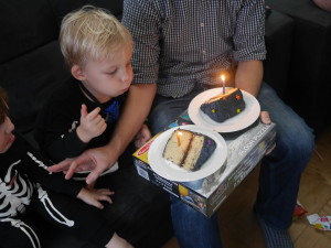 Singing Happy Birthday with leftover cake from his birthday.