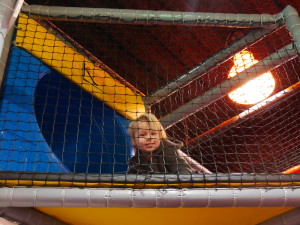 About to go down the slide in the climbing structure.
